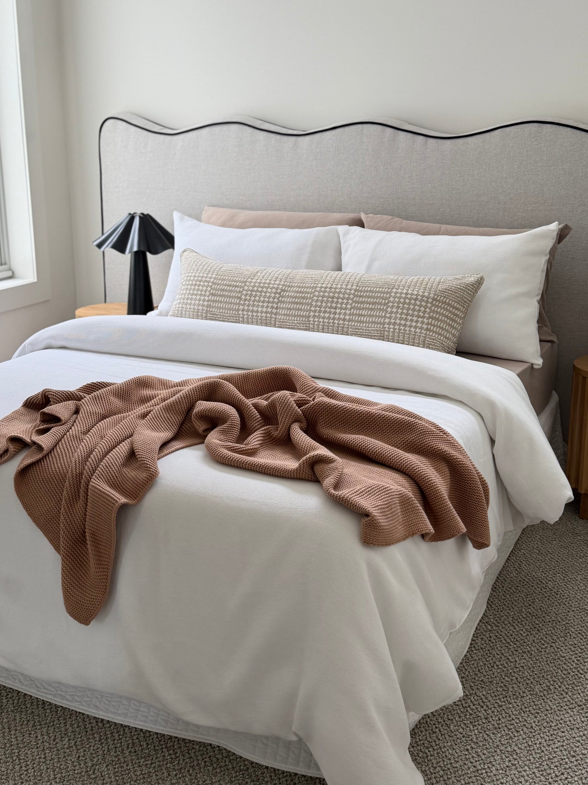 Terrain Coconut beige geometric long lumbar cushion, 105x38cm, styled across a bed