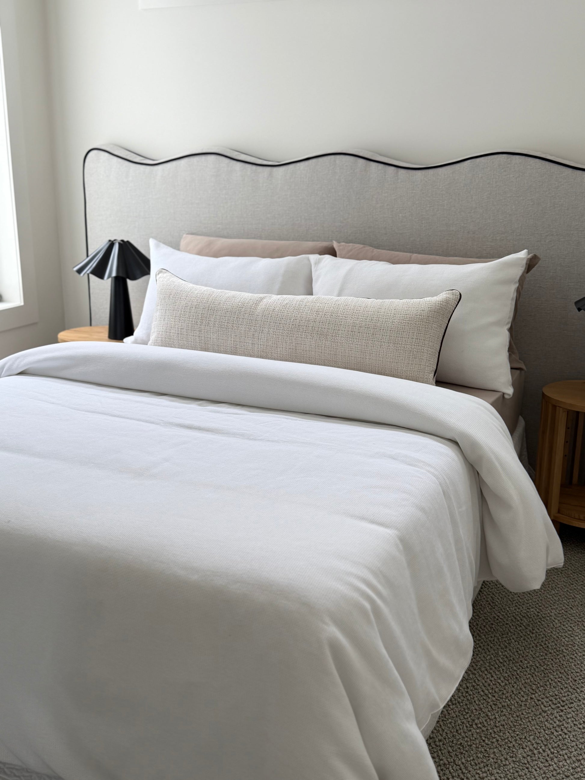 Conway Chalk cream long lumbar cushion with Dion Mocha piping, 105x38cm, styled across a bed